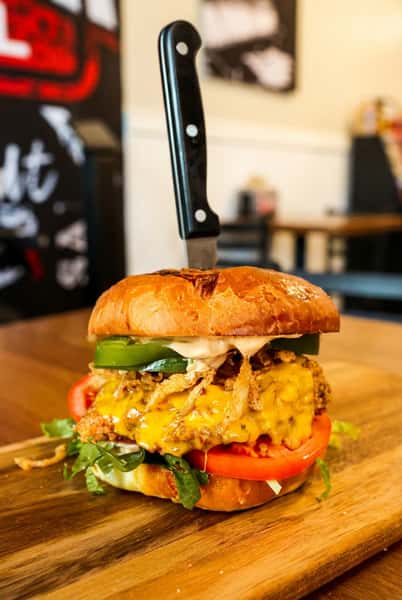 Burger with a knife through bun