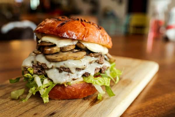 Saucy burger with lettuce and pickle slices