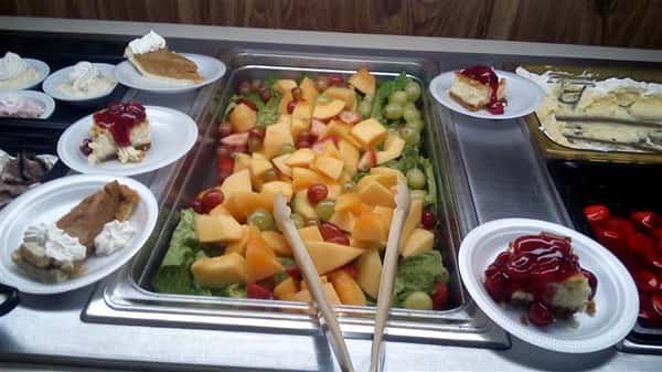 buffet assortment of fresh cut fruit and dessert pies
