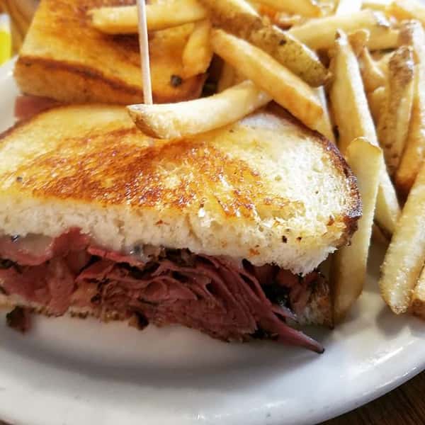 Pastrami melt sandwich with side of French fries