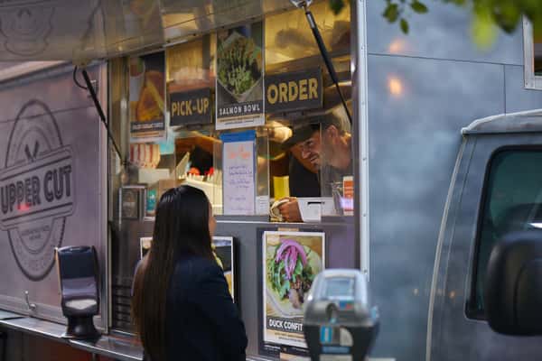Customer ordering from the Upper Cut food truck