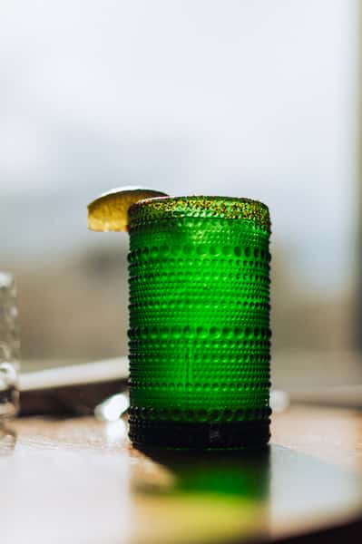 A beverage in a green glass