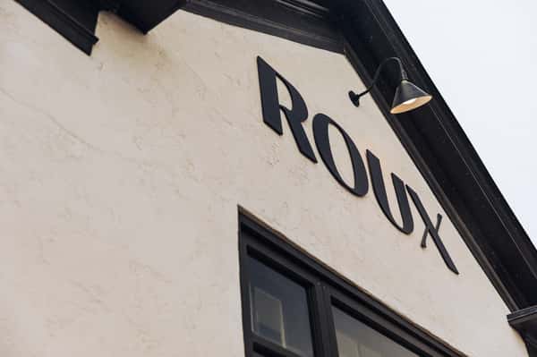 The exterior Roux sign on the front of the building