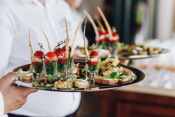 waiter carrying catering trays