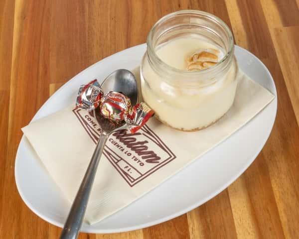 Creamy vanilla dessert mousse served in a glass jar with caramel topping.
