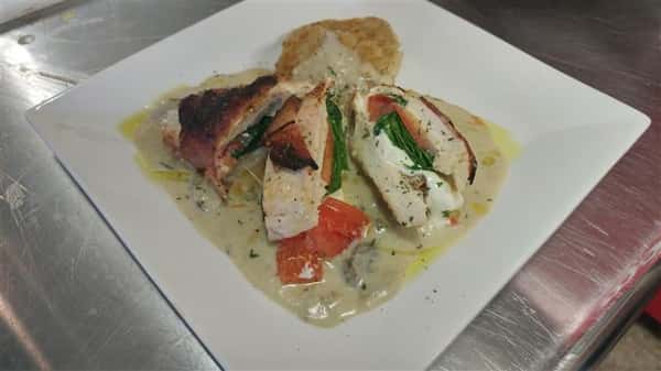 Chicken dish with tomatoes, spinach, mozzarella
