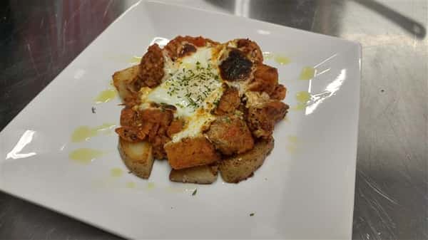 Tater tots tossed in black and white truffle oil and parmesan cheese