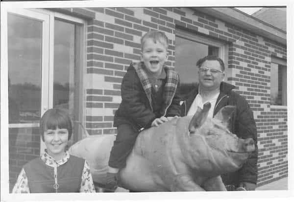 Vintage photo of Archie and two children on a pig ride.