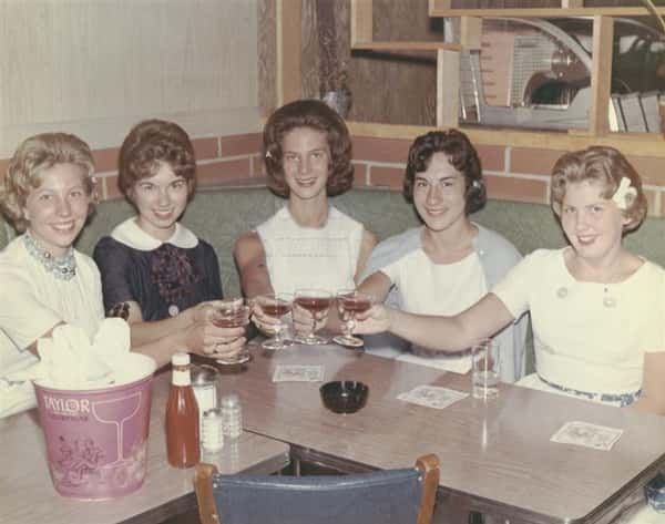 Vintage photo of five women toasting in a booth at archie's waeside