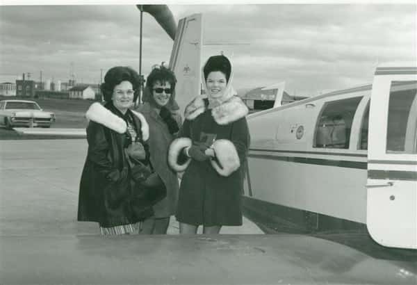 Vintage photo of three women boarding a private plane
