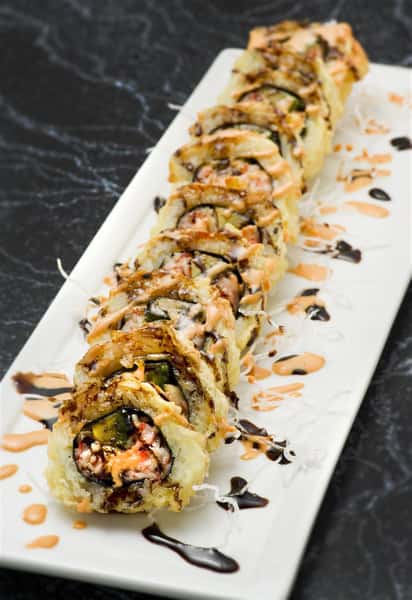 crab sushi roll with smoked eel and spicy mayo, covered and fried in tempura with a brown sauce drizzled on top