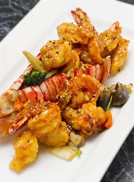 bangbang shrimp and lobster stuffed into a lobster tail serced with veggies