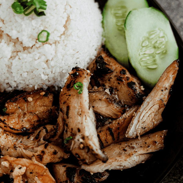 Close up of meat, salad, and rice meal