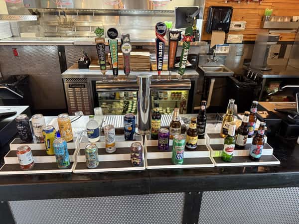 A variety of craft beers on tap and in cans and bottles are displayed behind the bar at Main Street Eats.