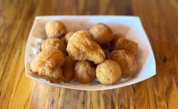 Fried hushpuppies are served in a boat tray at Main Street Eats.