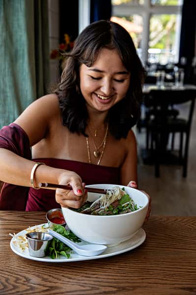 Woman eating pho