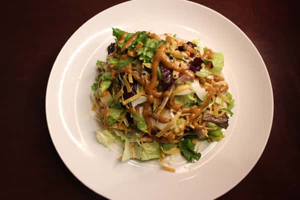 Salad of mixed greens topped with sautéed mushrooms and onions