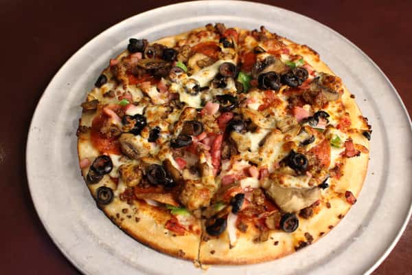 Specialty pizza topped with black olives, tomatoes, and cheese