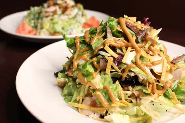 Southwest-style salad with black beans, corn, avocado, and crispy tortilla strips