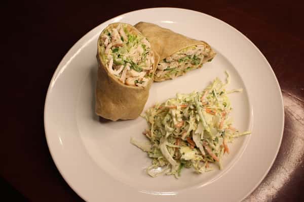 Chicken wrap cut in half, served with a side of coleslaw