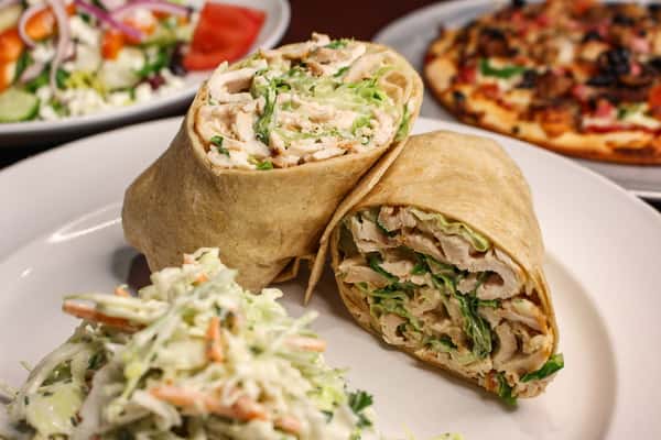 Wrap sandwich cut in half, served with coleslaw and french fries