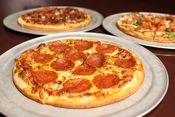 Pepperoni pizzas served on plates