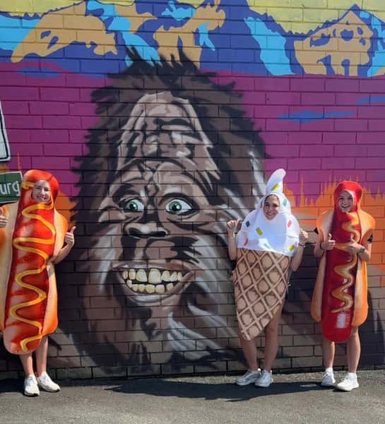 exterior wall art with people dressed as hotdogs and ice cream
