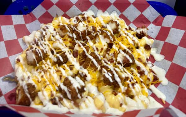 Crispy chicken, bacon bits, and a drizzle of ranch atop a base of hand cut fries or mac-n-cheese