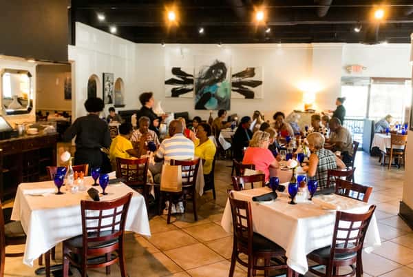 Customers seated inside restaurant enjoying meals