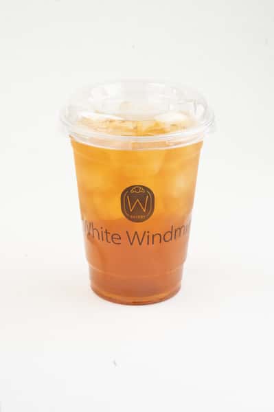 Iced amber iced tea with visible ice cubes in a clear branded takeaway cup, featuring a refreshing layered look and clean café-style presentation on a minimal background.