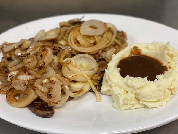 liver smothered with onions and a side of mashed potatoes topped with gravy