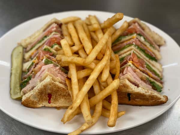 turkey club sandwich with a side of french fries