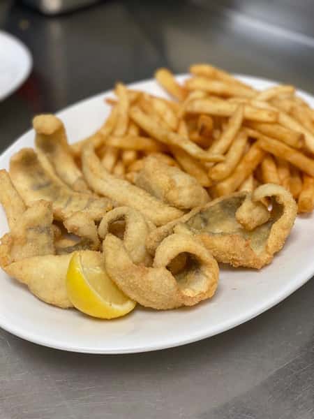 fried clam strips with a side of fries and lemon wedge