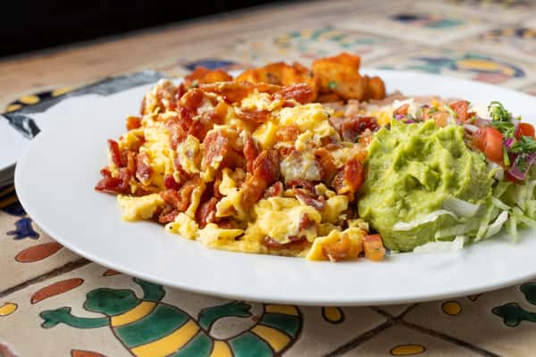 Bacon Breakfast Plate with a side of guacamole on a white plate