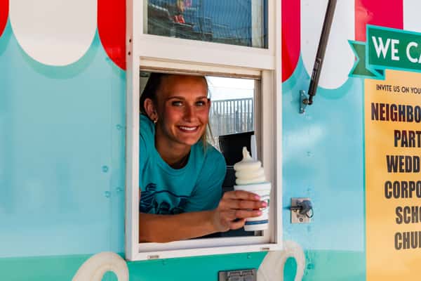 Server holding a frozen treat at the window