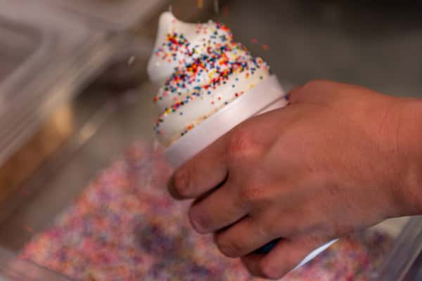 Sprinkles being added to frozen custard