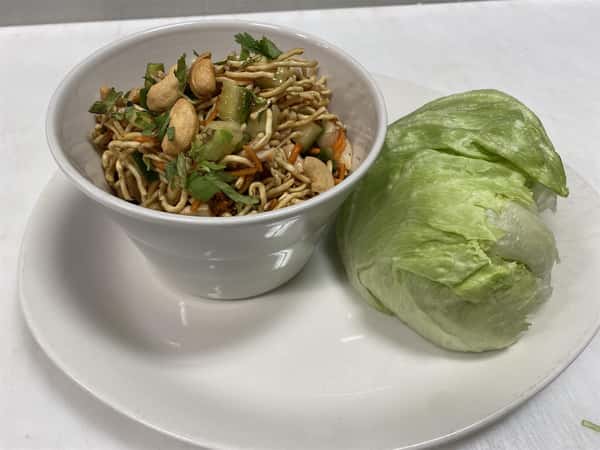 thai lettuce wraps appetizer: half head of iceburg lettuce with cup of lettuce wrap fillings