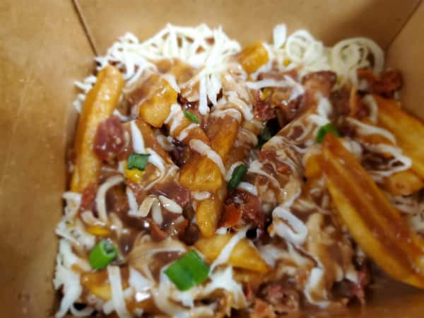 poutine: french fries covered in cheese, gravy, bacon and chives