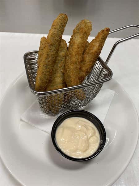 fried pickle spears in a basket with a side of dipping sauce