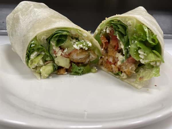 crispy chicken wrap with ranch dressing, tomatoes, lettuce and cheese