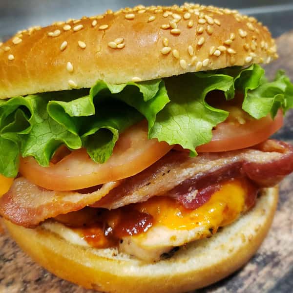 grilled chicken sandwich with bacon, BBQ sauce, lettuce, cheese and tomatoes