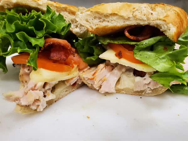 turkey club sandwich with bacon, cheese, lettuce and tomato