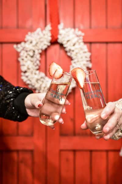 toasting in front of red barn doors