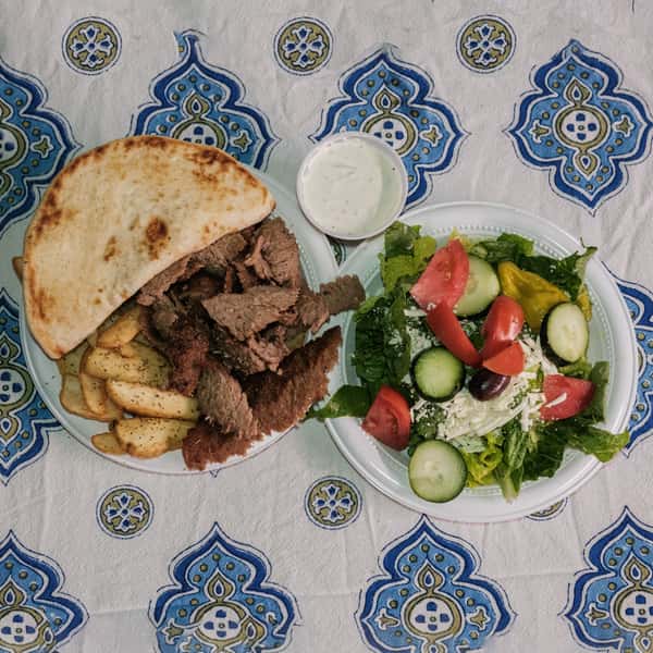 Two greek dishes on white plates