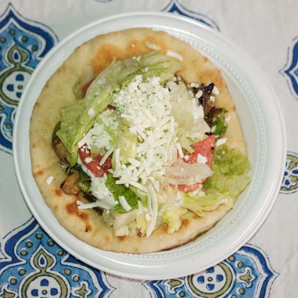 Unwrapped gyro on a white table