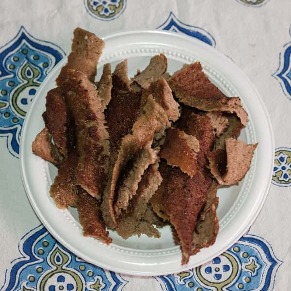 Top view of a white dish full of meat