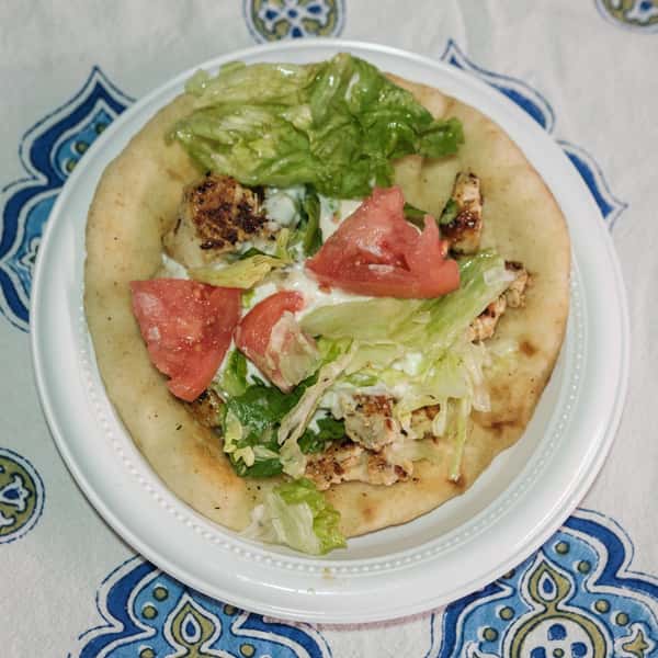 Unwrapped gyro on a white table