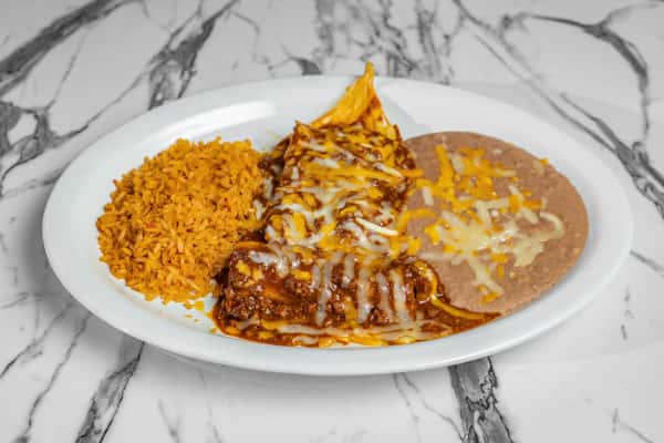 Classic cheese enchiladas smothered in chili sauce and melted cheese, served with seasoned rice and refried beans — comforting Tex-Mex combo plate.
