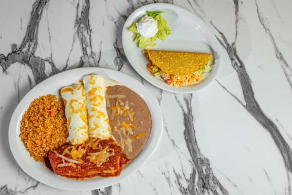 Classic Mexican combo plate featuring cheesy enchiladas, refried beans, Spanish rice, and a crispy taco with lettuce, tomato, and sour cream on the side.