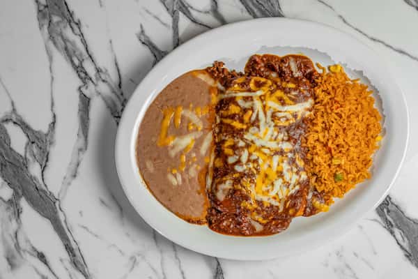 Cheesy beef enchiladas covered in rich red enchilada sauce, served with creamy refried beans and traditional Mexican rice.